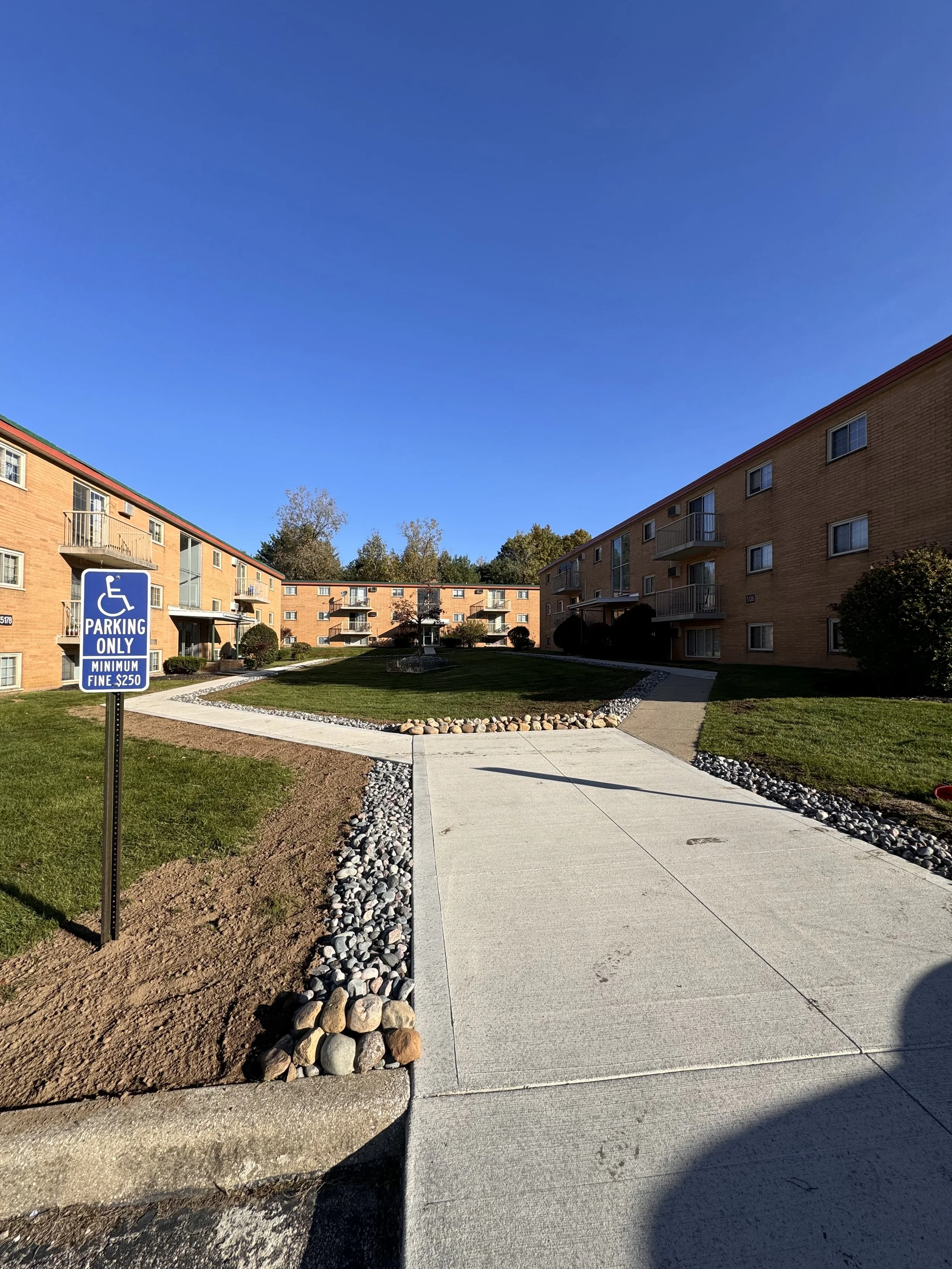 Walkway and grounds at a multi-family brick apartment community