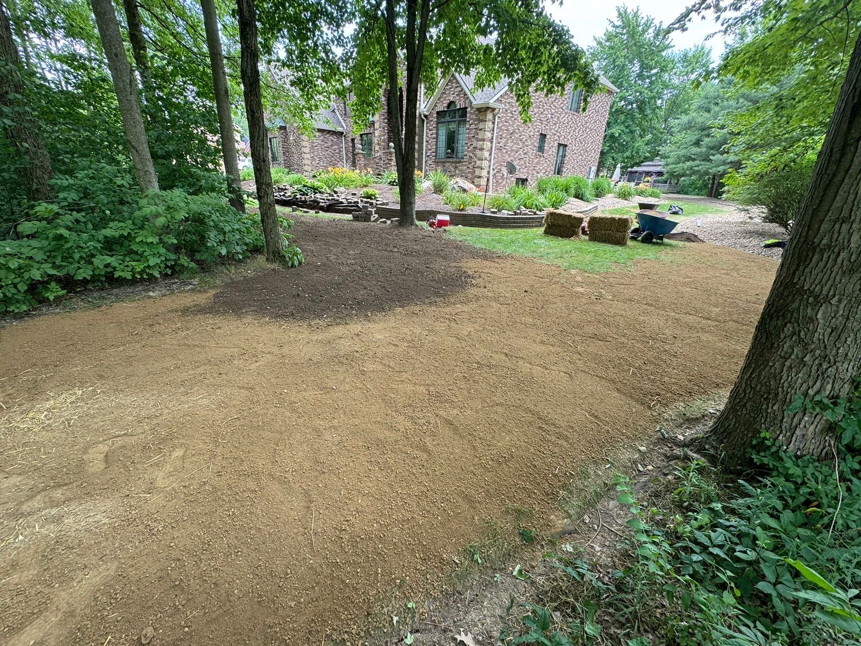 Cleared backyard graded with sod staged for install