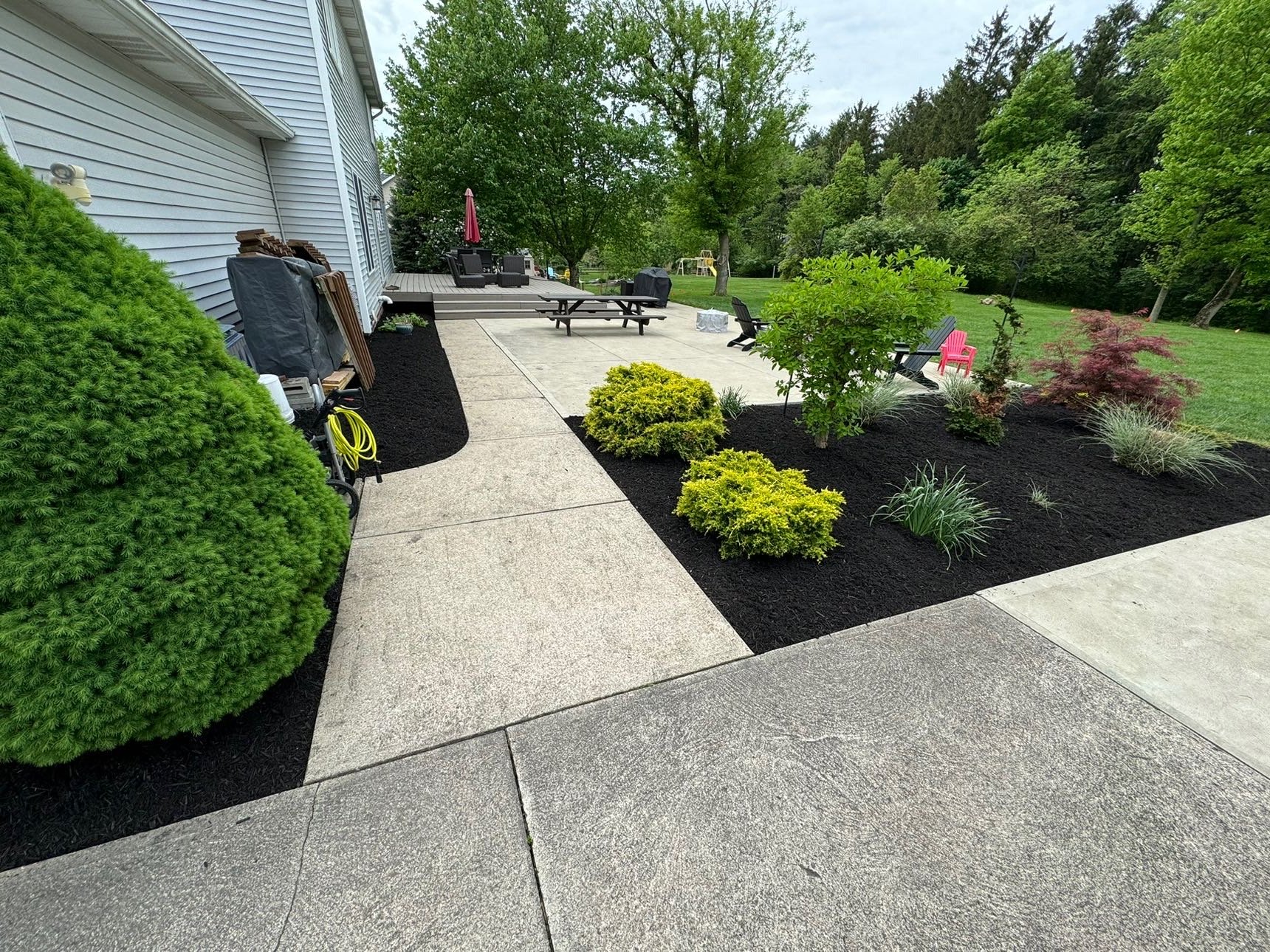 Landscaped beds and shrubs along a home walkway