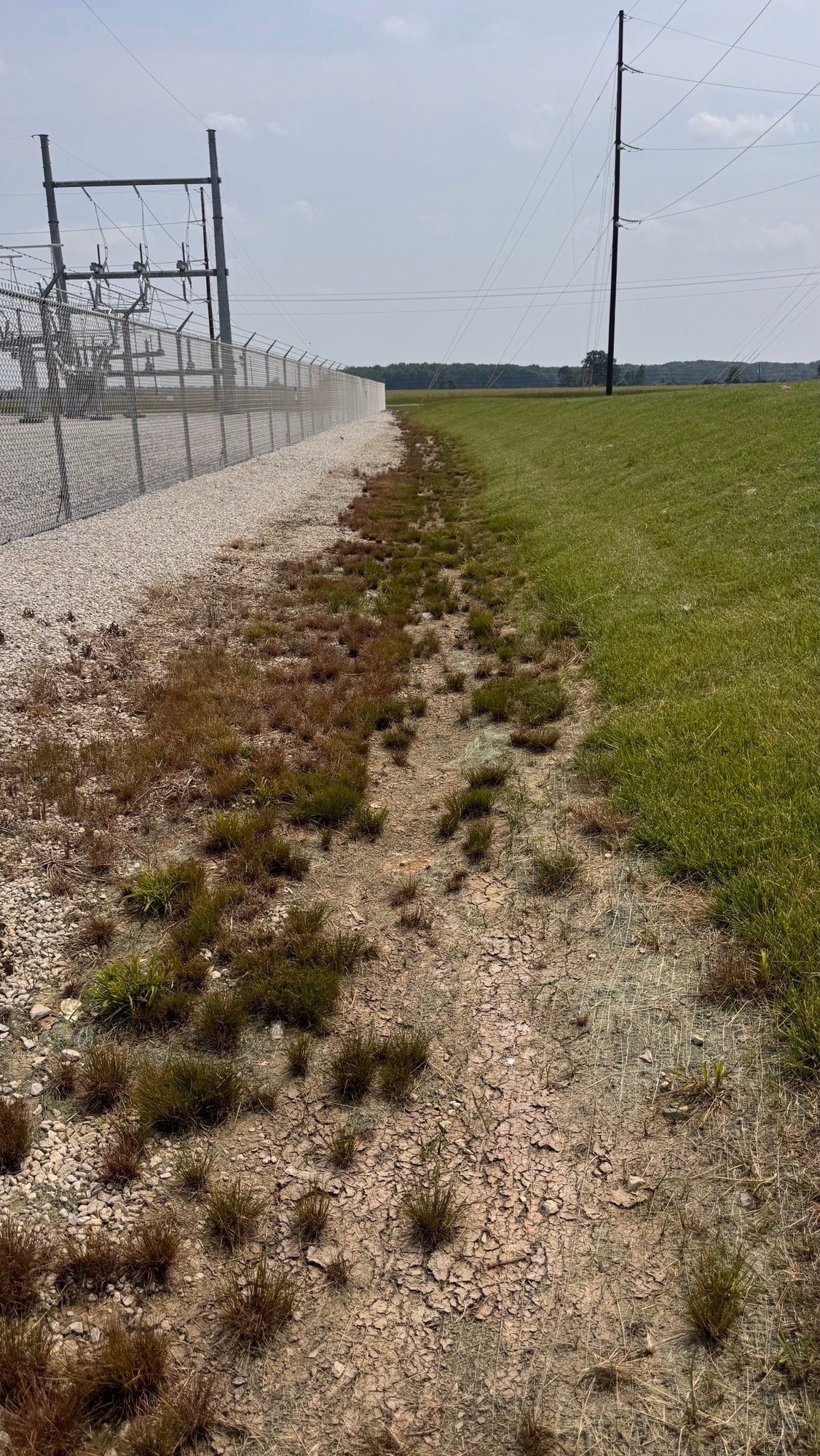 Stone drainage channel installed along a utility site