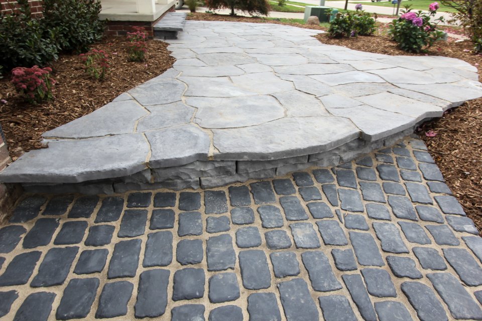 Mixed cobblestone and flagstone garden pathway with plantings