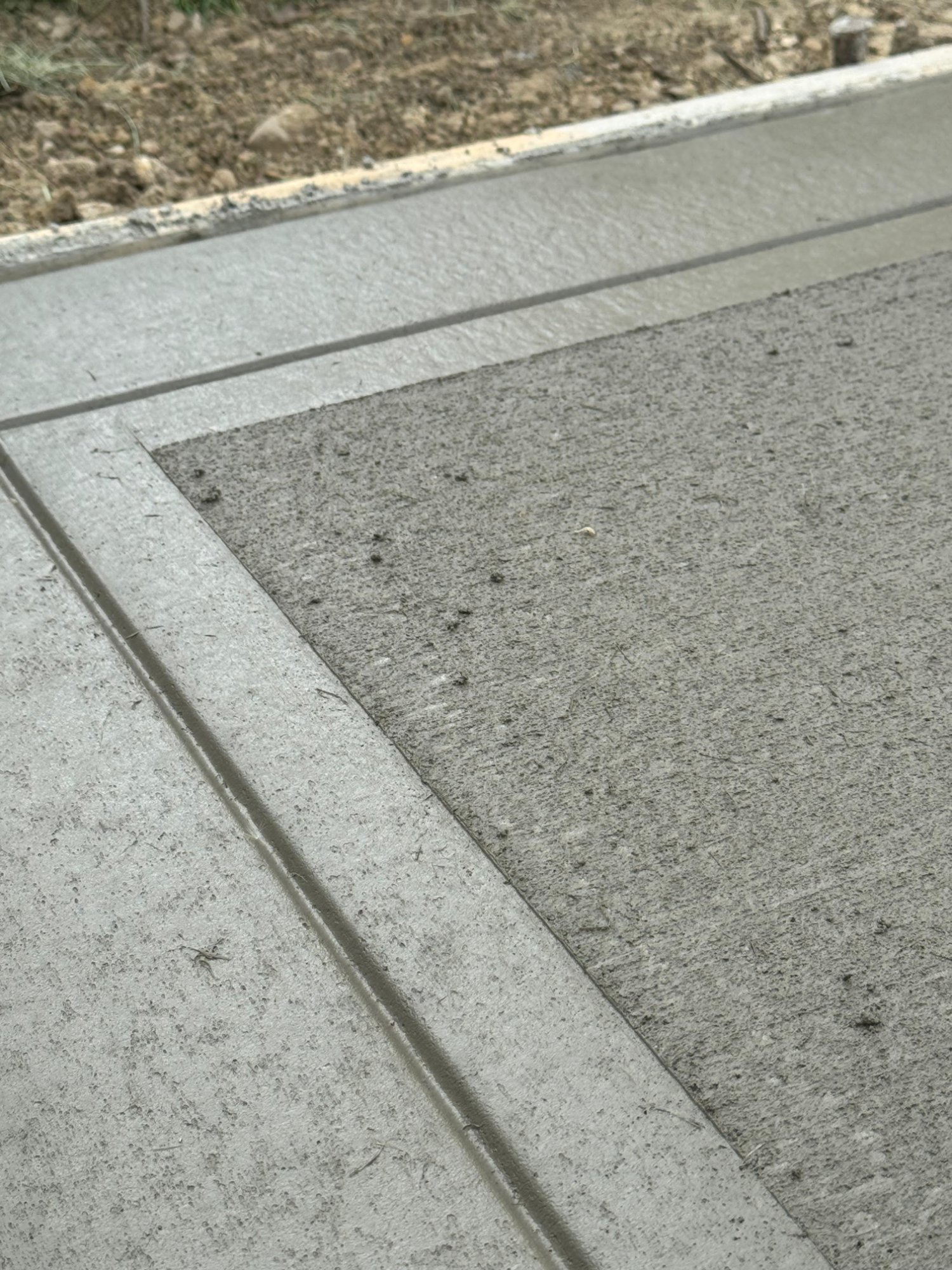 Newly stamped concrete patio with decorative stone pattern