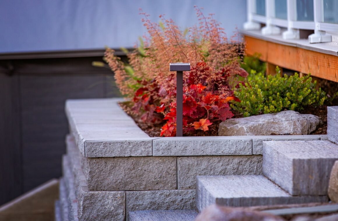 Stone steps with path lighting through planted beds