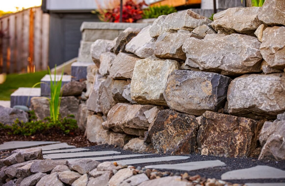 Stone retaining wall and landscaped garden bed with pathway